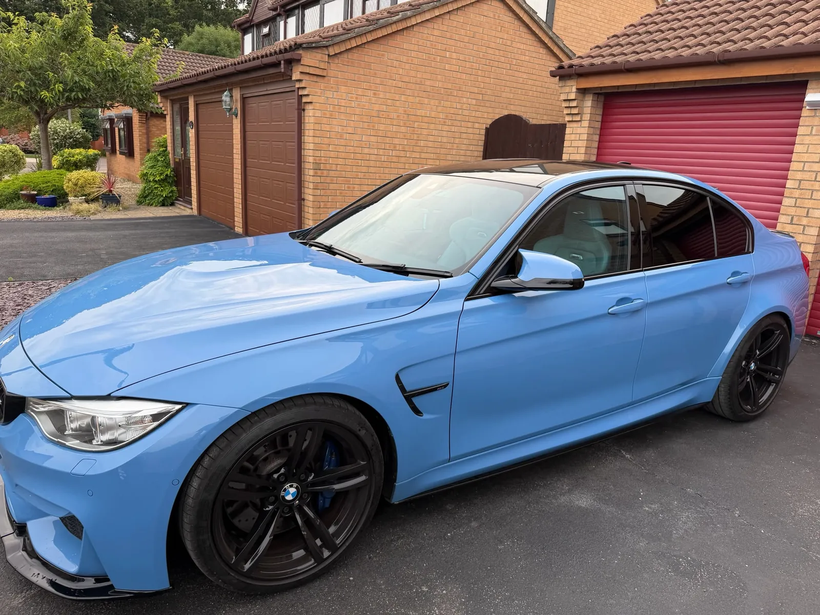 Blue BMW saloon with tinted windows